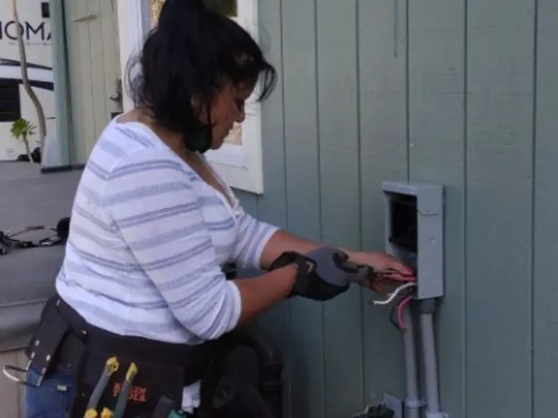 Licensed electrician wiring an exterior subpanel in Frankfort