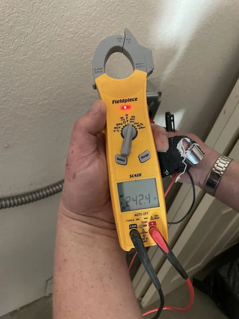 Voltage testing with clamp meter during Recessed Lighting Installation in Frankfort